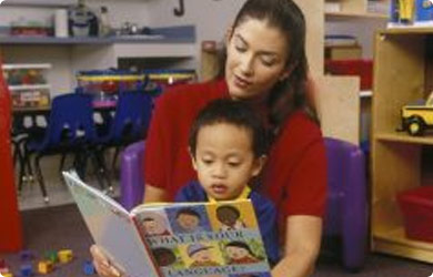Teacher is reading a book to her student
