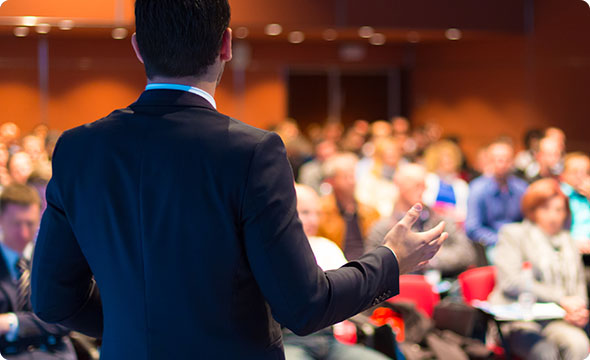 Man is presenting in front of an audience.